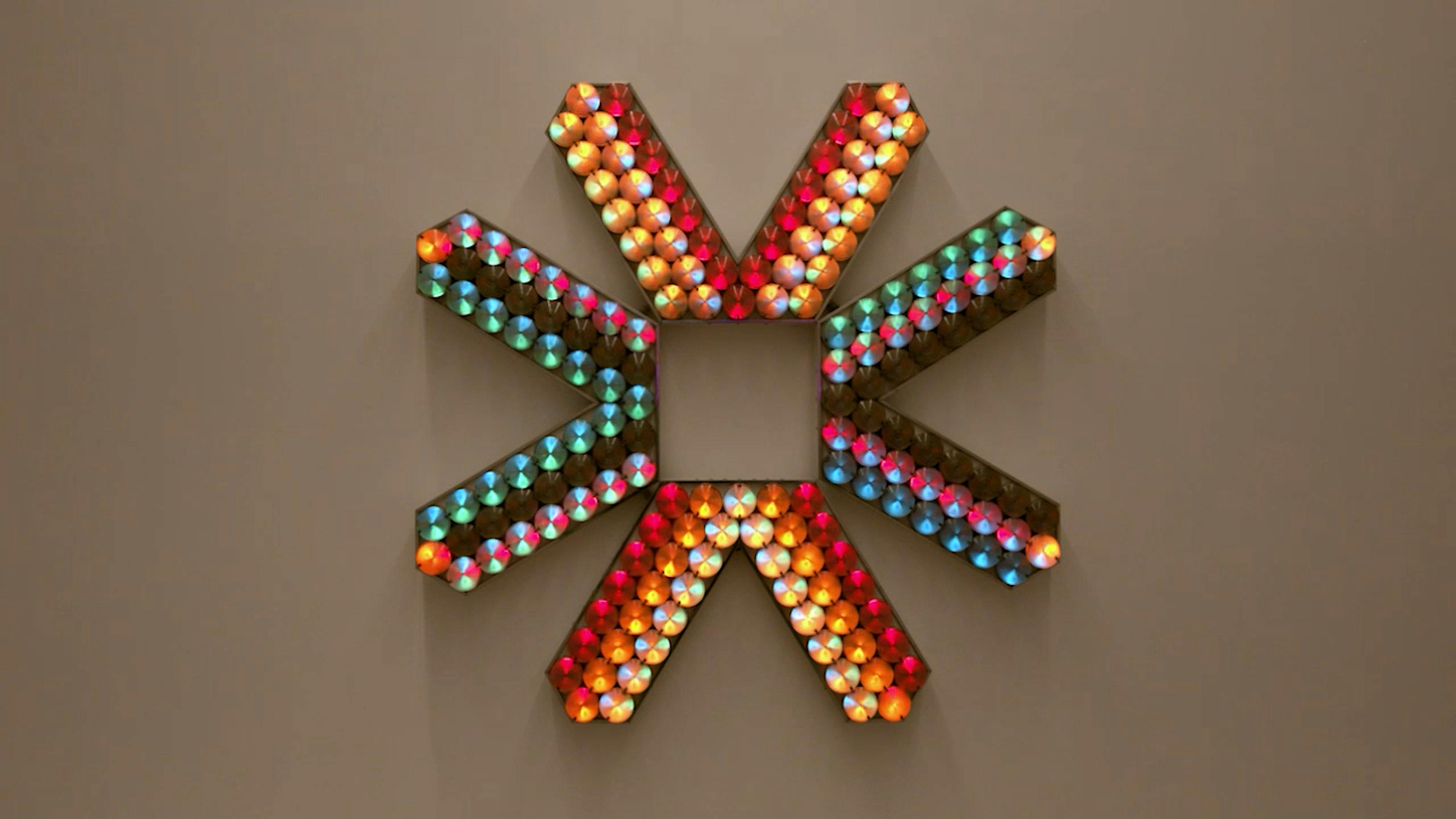 An electronically powered light sculpture with different color lightbulbs lighting up in different sequences.