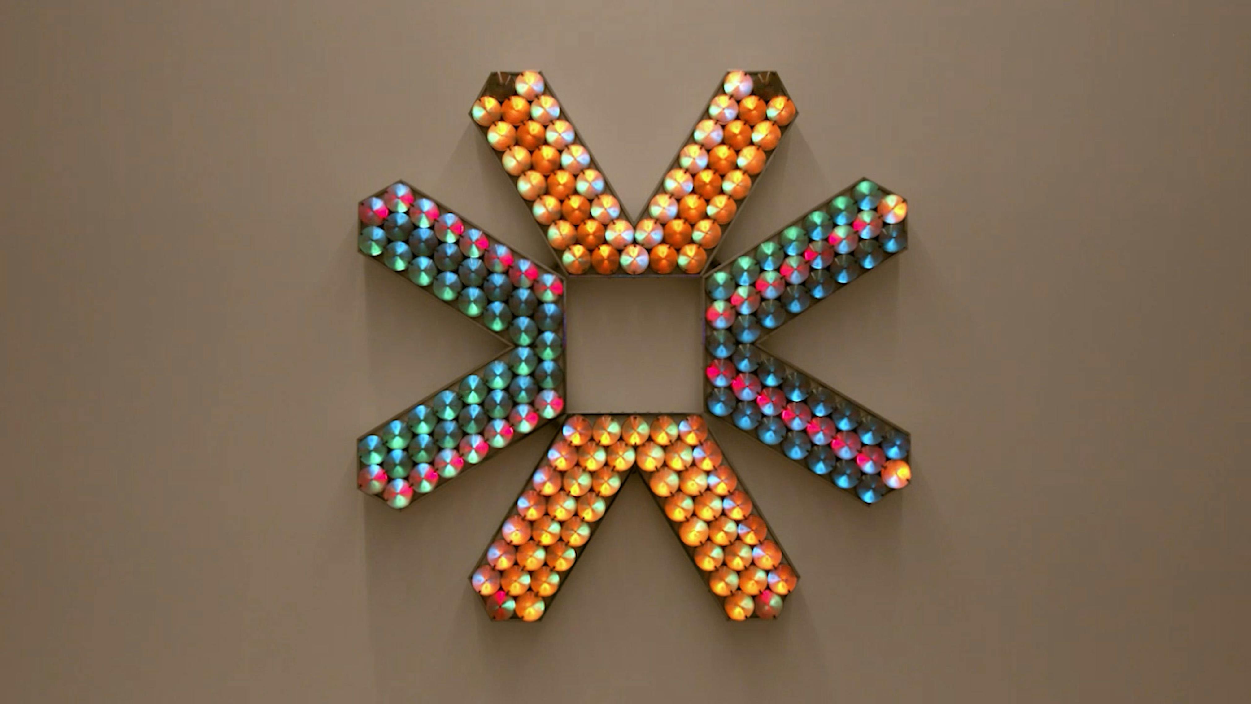 An electronically powered light sculpture with different color lightbulbs lighting up in different sequences.