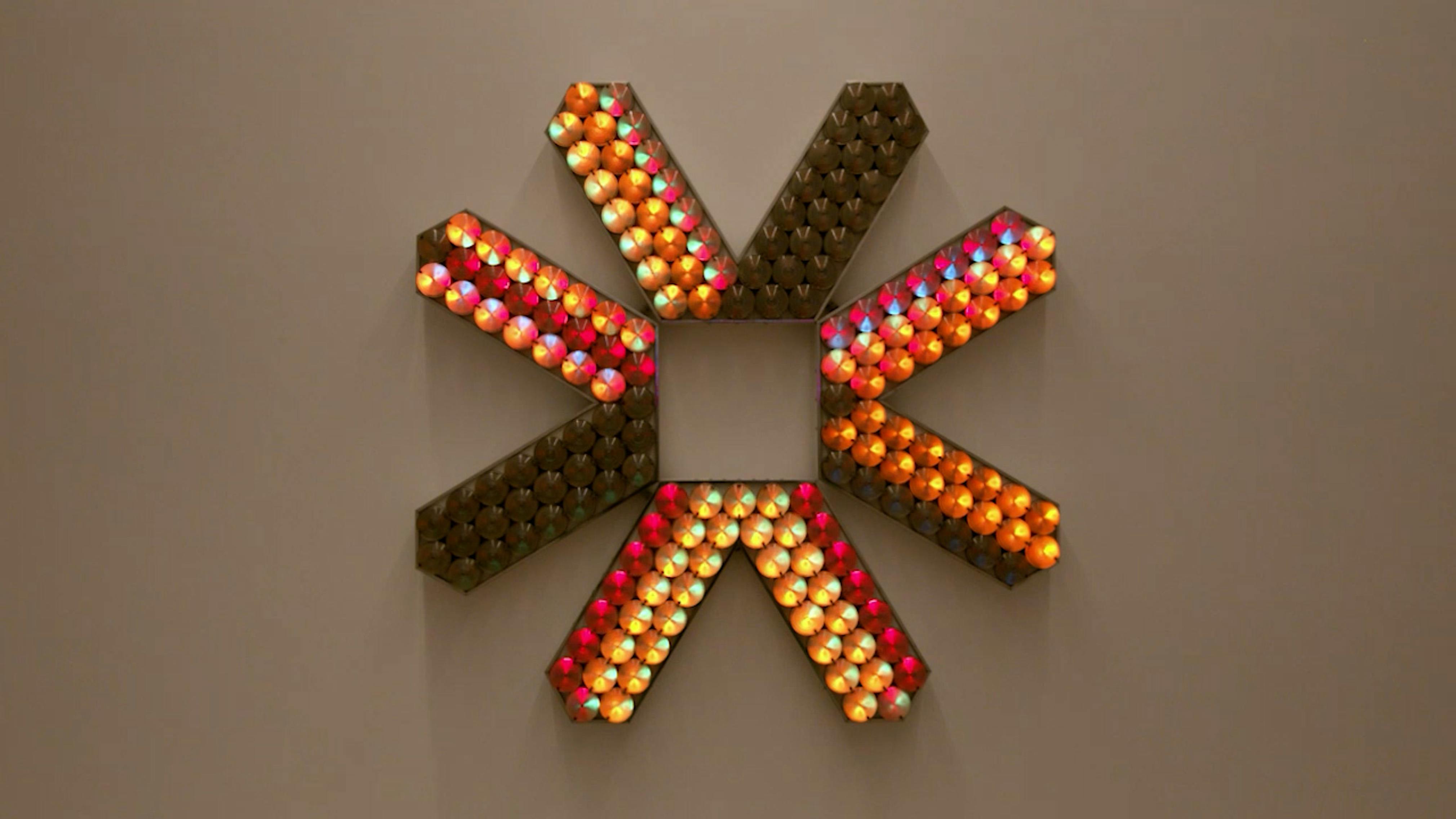 An electronically powered light sculpture with different color lightbulbs lighting up in different sequences.