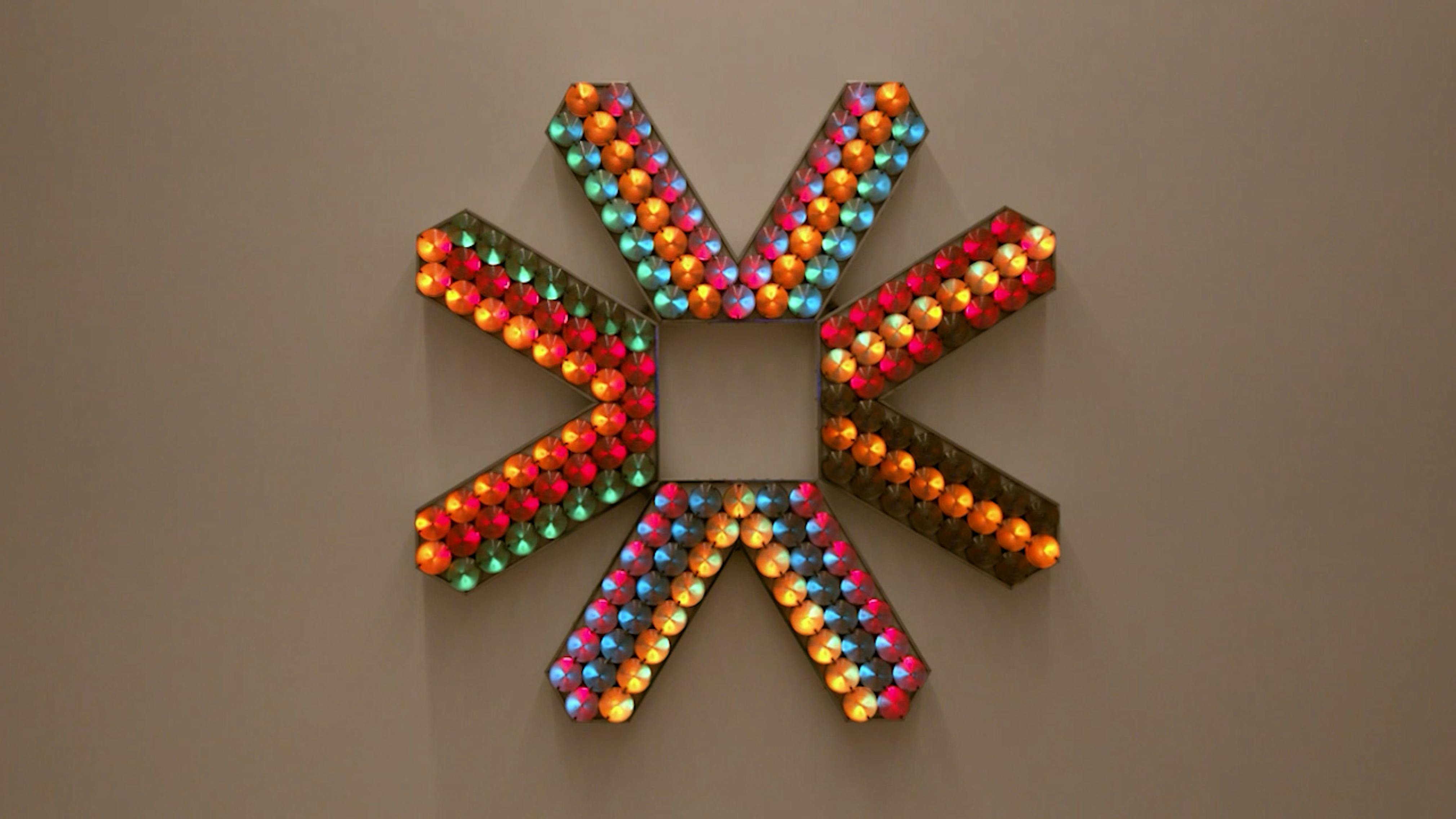 An electronically powered light sculpture with different color lightbulbs lighting up in different sequences.
