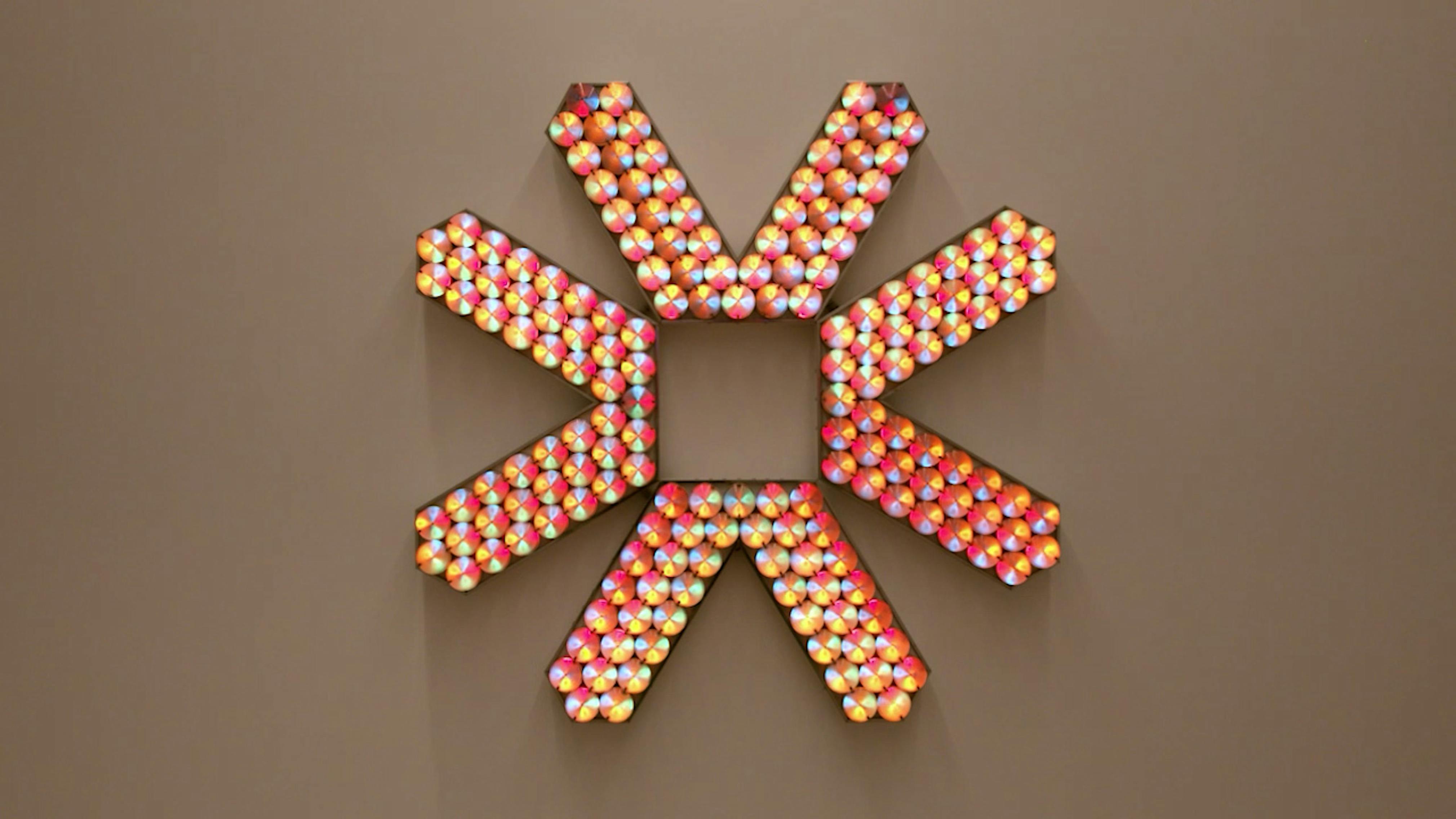 An electronically powered light sculpture with different color lightbulbs lighting up in different sequences.