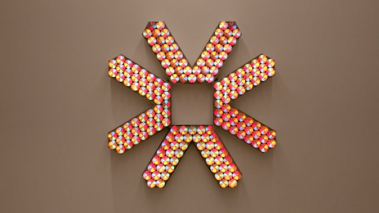 An electronically powered light sculpture with different color lightbulbs lighting up in different sequences.