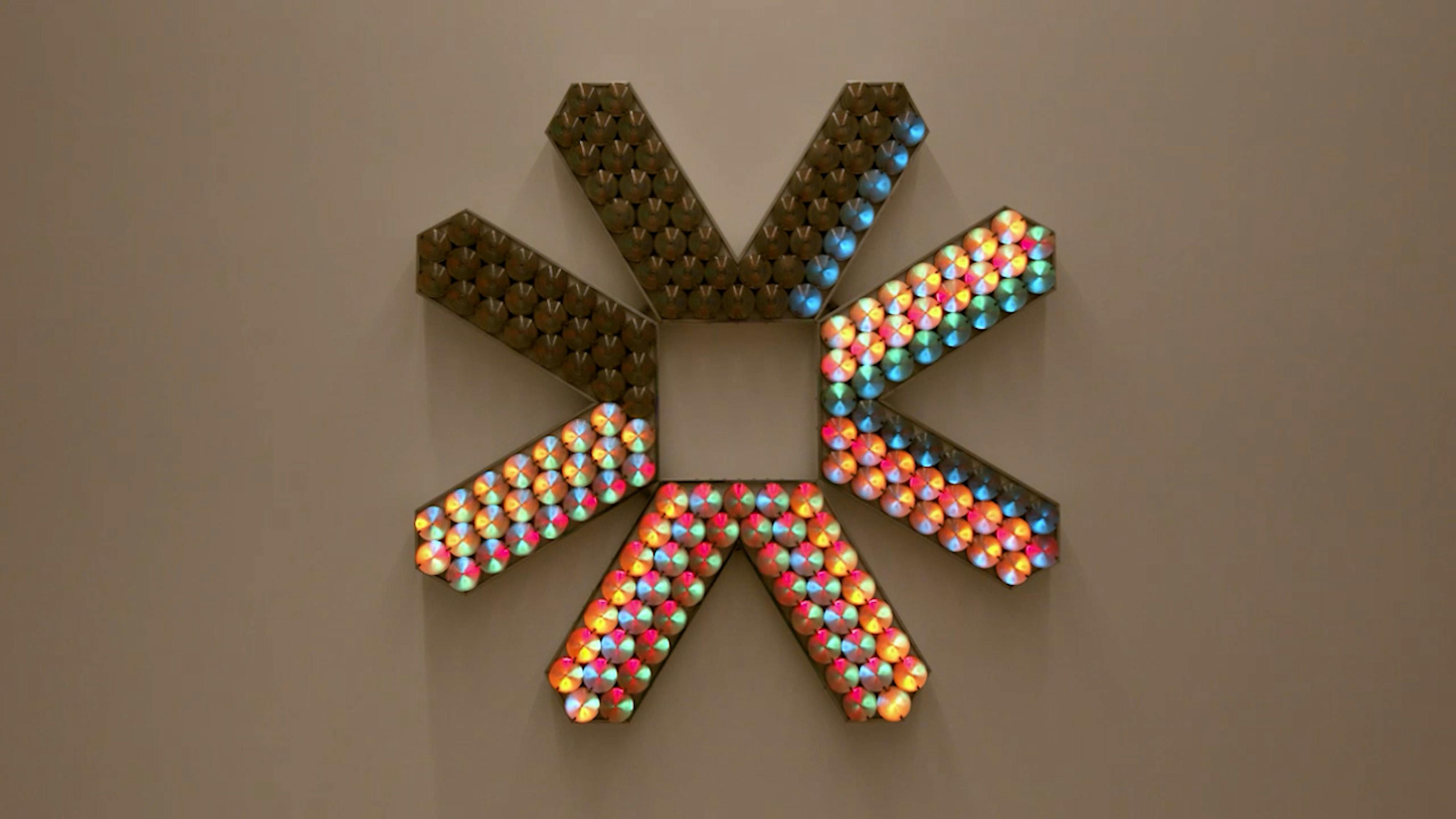 An electronically powered light sculpture with different color lightbulbs lighting up in different sequences.